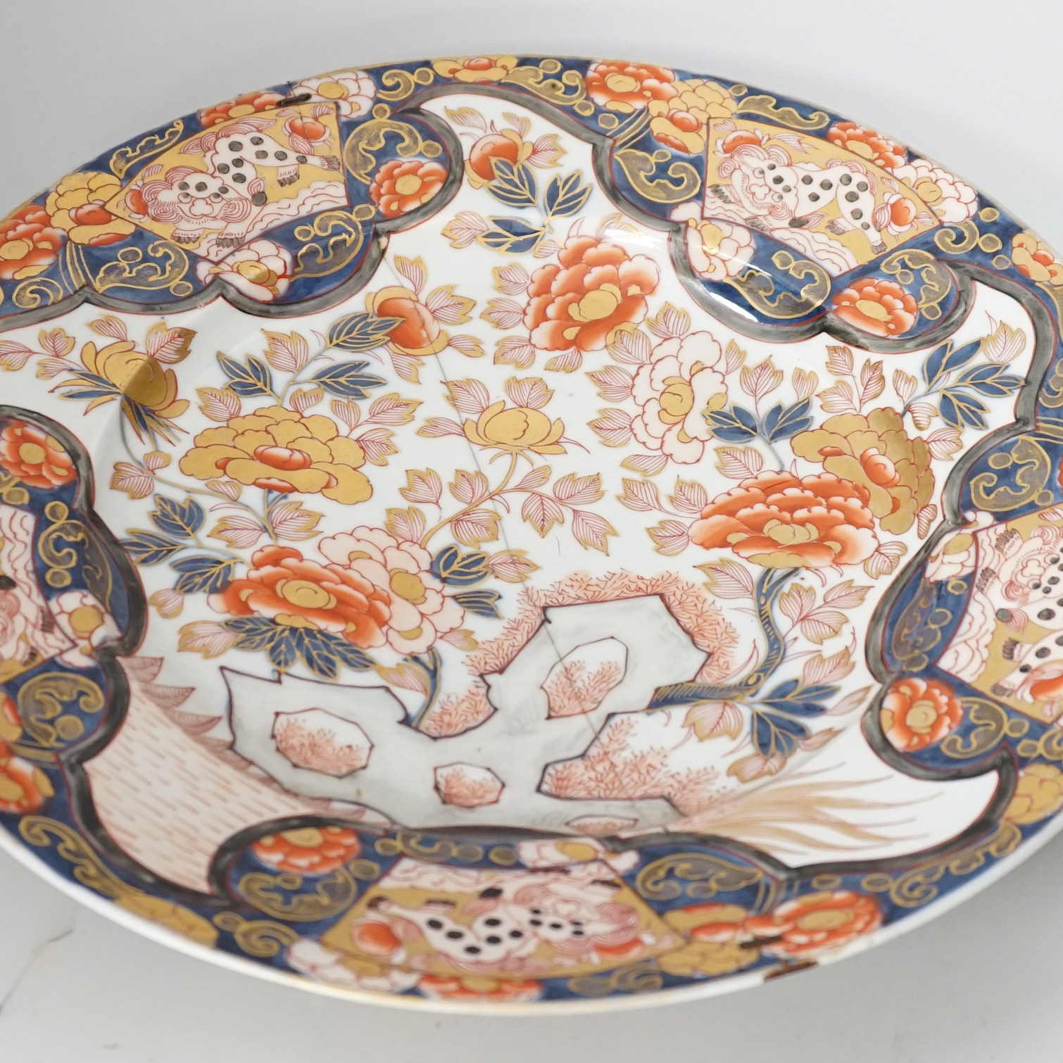 A pair of 19th century Japanese Imari vases, a similar charger, an earlier cracked and riveted charger and a blue and white charger, (5), largest charger 47cm diameter